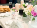 An elegant table setting for a formal event with candles and floral accents.
