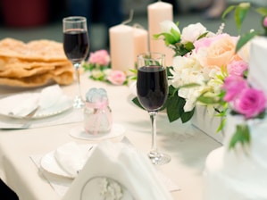 A beautifully arranged table set for a formal event with elegant tableware and floral centerpieces.