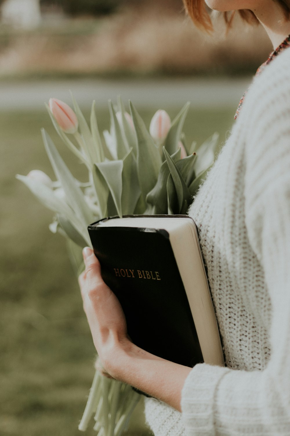 woman holding Holy Bible