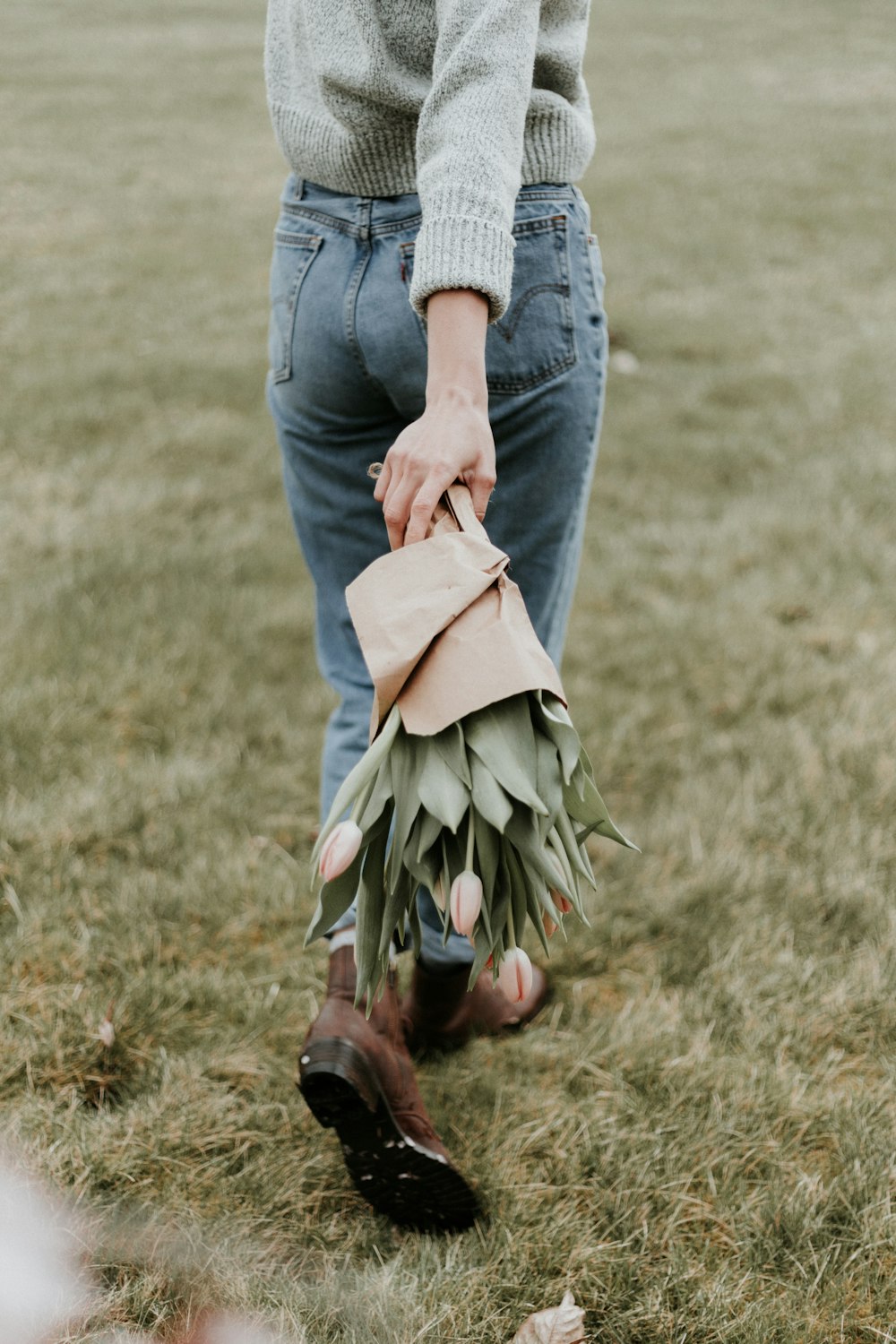 person holding bouquet of tulips