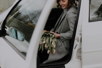 woman inside white vehicle mother's day teams background