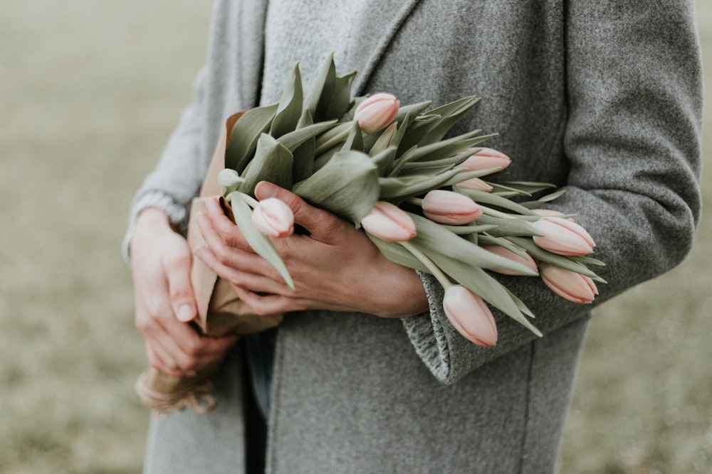 person holding bouquet of tulip flowers