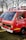 A red fire service vehicle with the words 'FEUERWEHR' and 'Jugendfeuerwehr Mindelheim' painted on the side. The vehicle has a Volkswagen emblem on the front. It is parked outdoors on grass with other vehicles nearby. There are emergency lights and loudspeakers mounted on the roof.