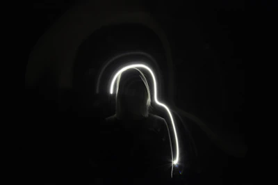 Silhouette of a figure bathed in warm, ethereal light.