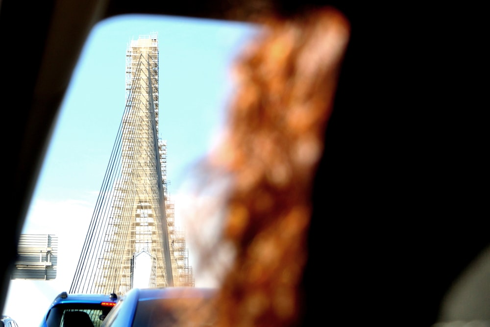 a view of a very tall building from inside a car