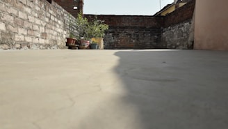 A freshly poured concrete terrace with clean lines and natural stone edging.