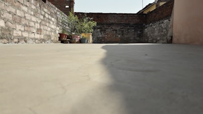 A freshly poured concrete terrace with clean lines and natural stone edging.