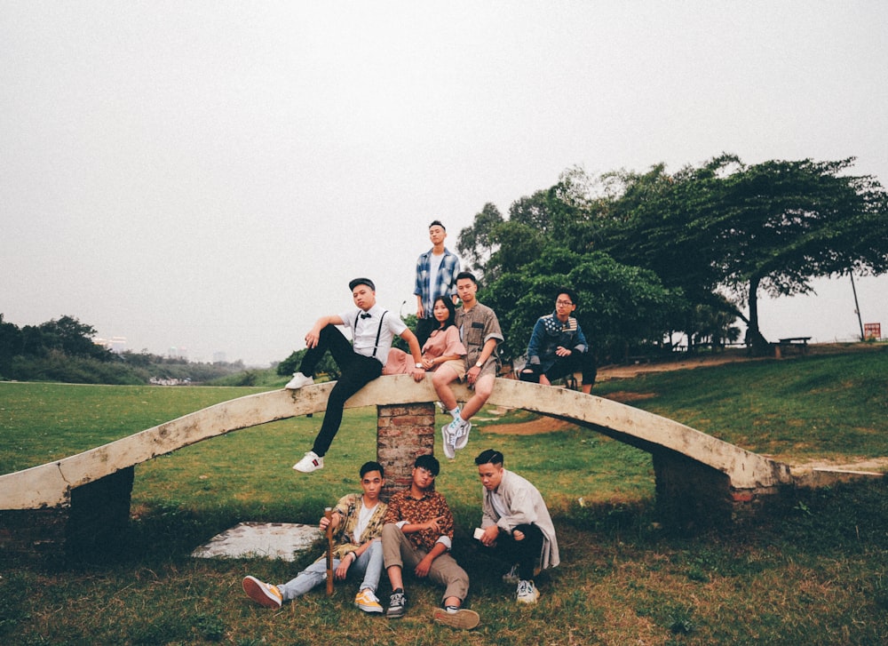 group of people sitting on bridge