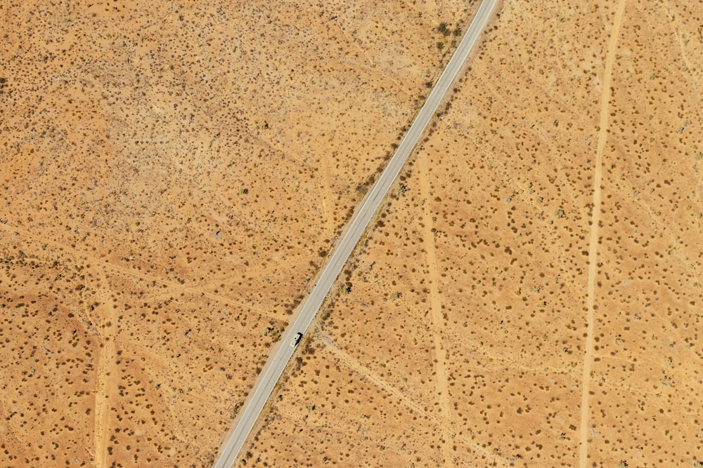 aerial photography of road between vast desert