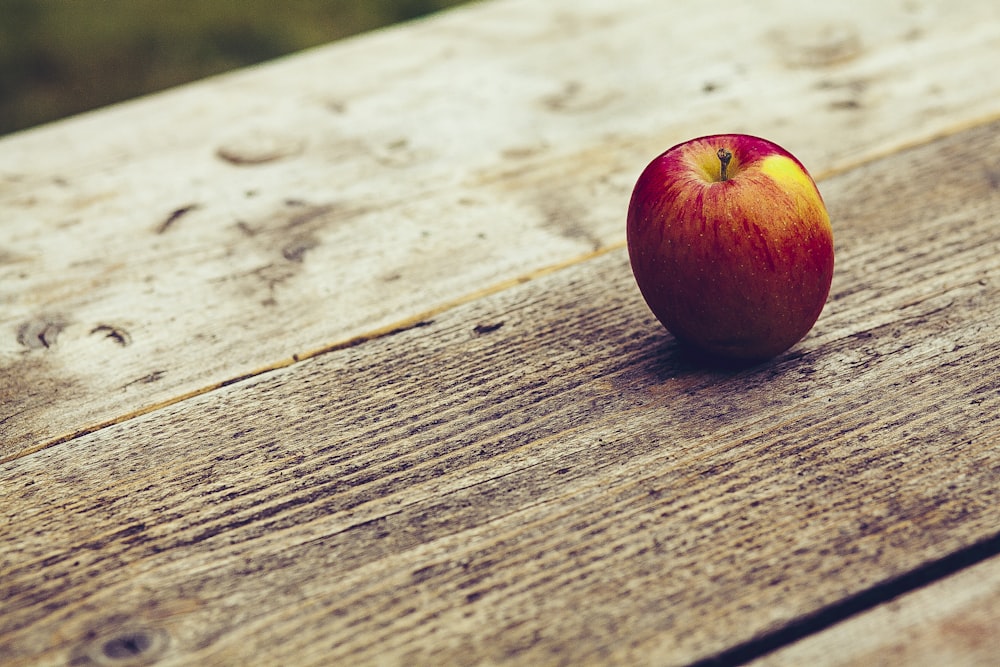 red apple on brown surface