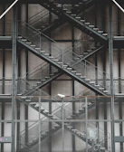 Close-up of galvanized steps attached to a container, highlighting sturdy craftsmanship.