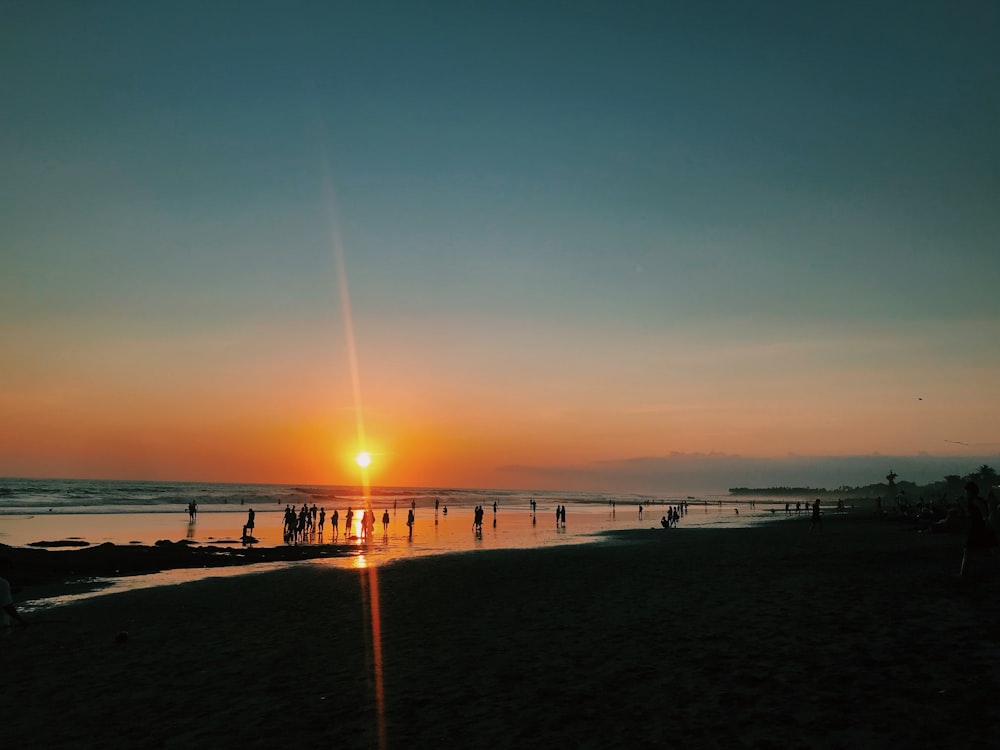 silhouette of people at the beach