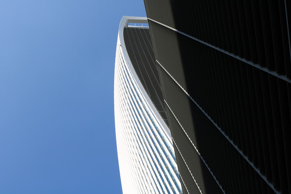 grey and black high rise building under clear blue sky