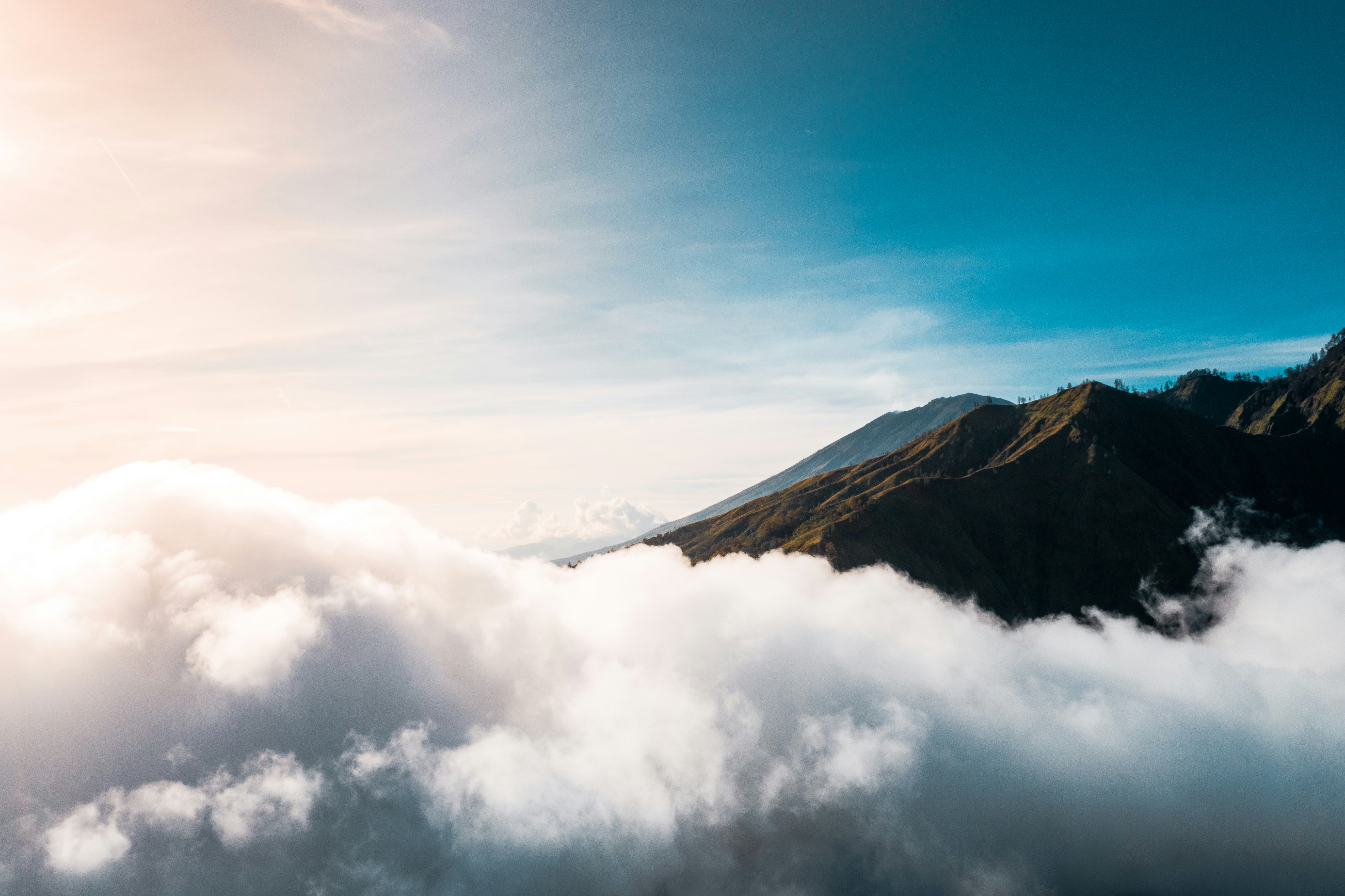 view of foggy mountain during daytime