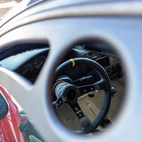 Interior shot showing a custom steering cover and dashboard accessories enhancing the car’s look.