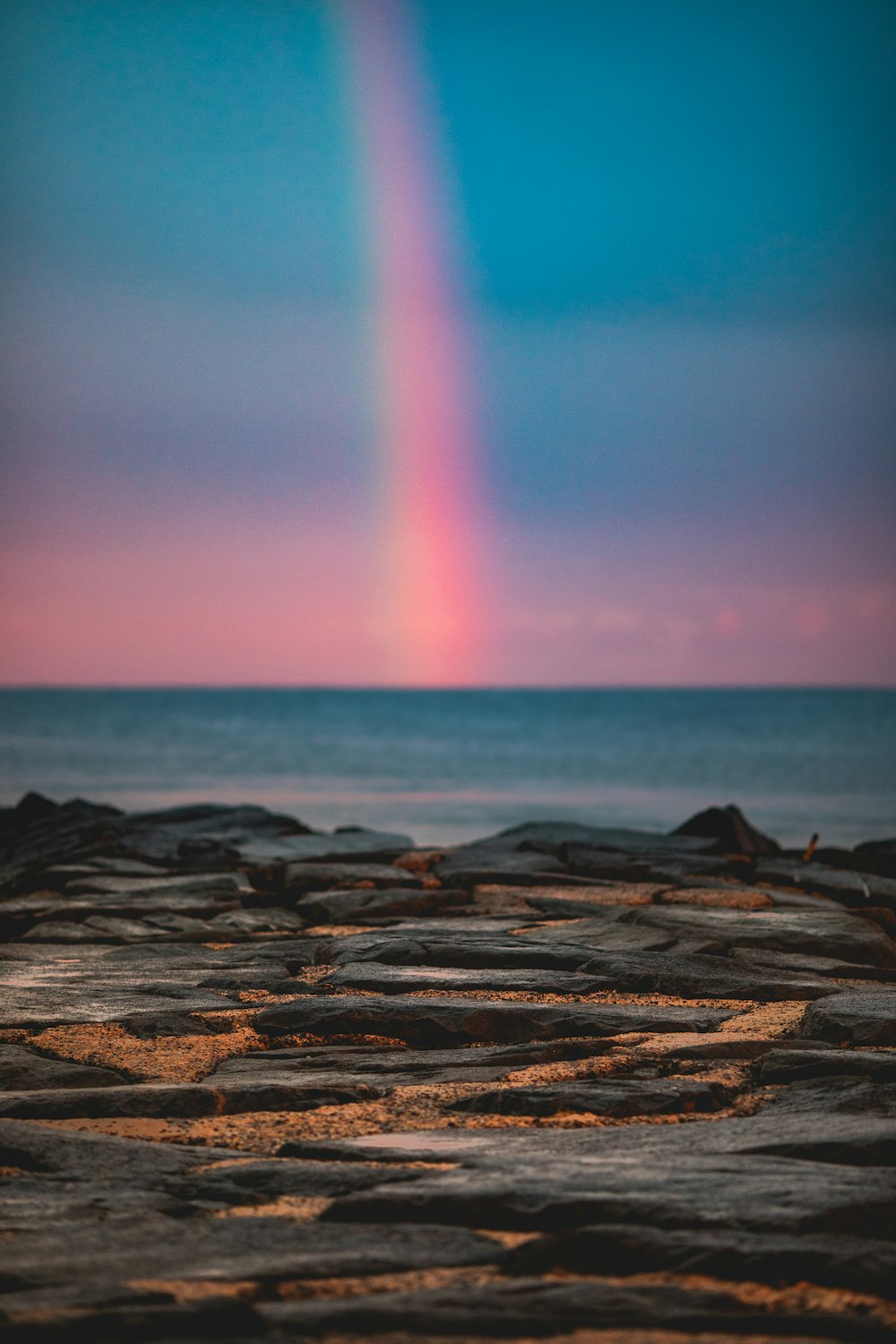 rainbow at sea during sunset