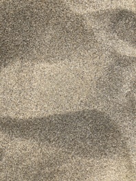 A close-up of fine silica sand in a glass container.