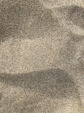 A close-up of fine silica sand in a glass container.