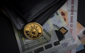 a bitcoin sitting on top of a pile of money