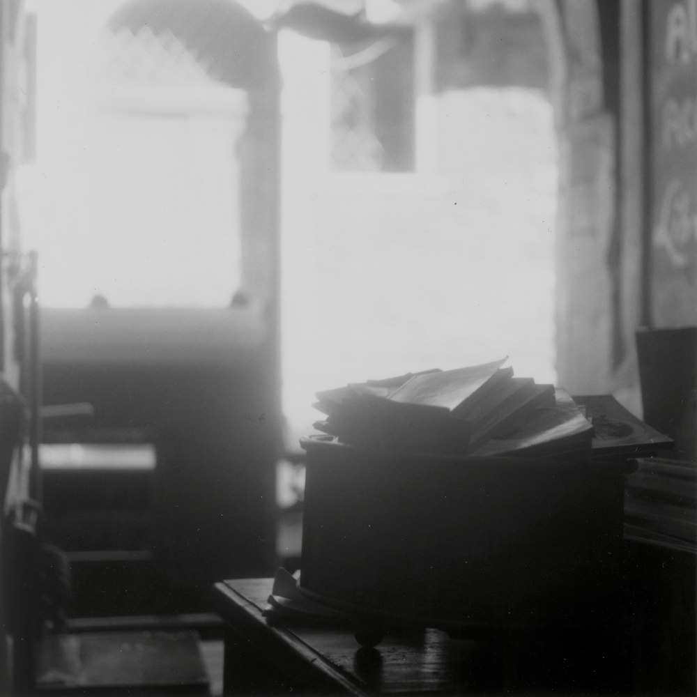 a stack of books sitting on top of a wooden table