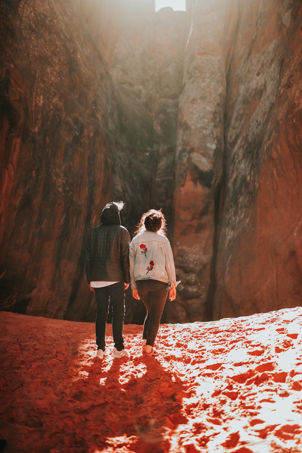 man and woman standing while facing on mountain