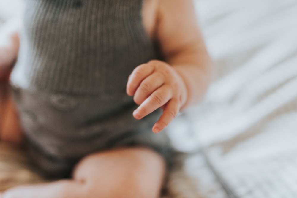 baby wearing gray top