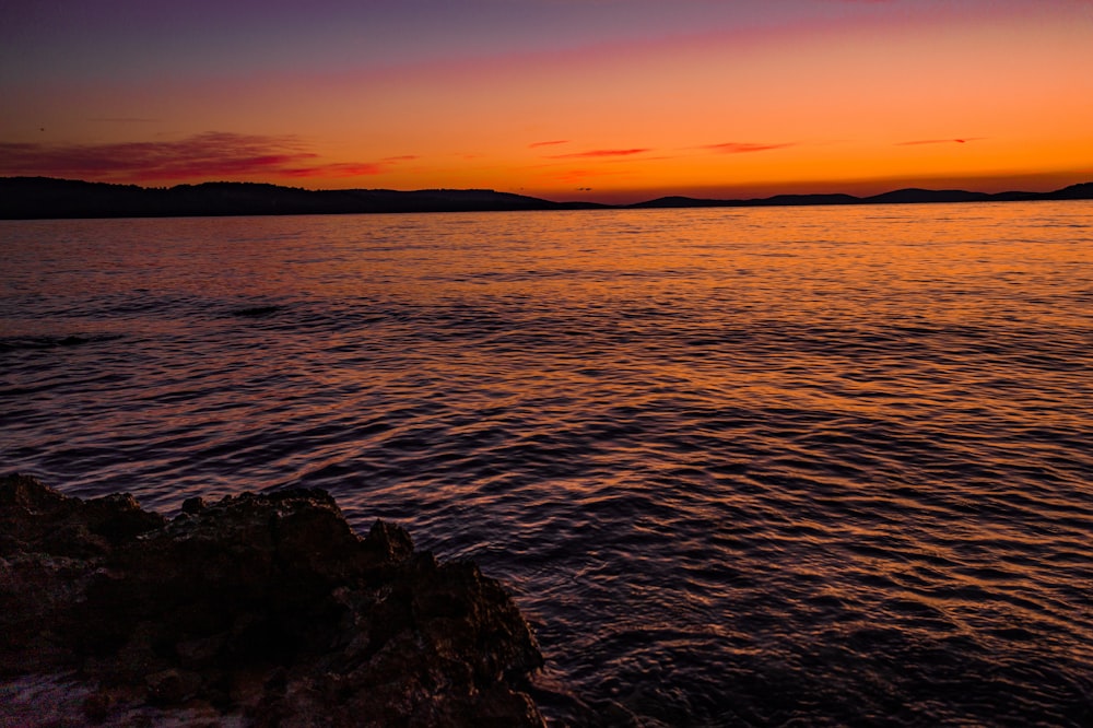 calm sea and mountain under sunset view