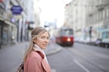 selective focus photography of woman standing near train during daytime