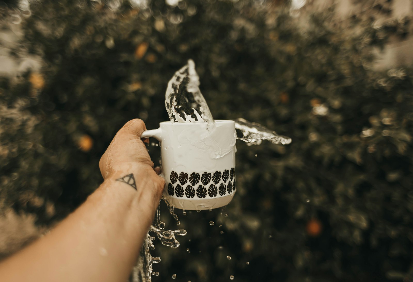 Canon EF 28mm F1.8 USM sample photo. Person tossing water in photography