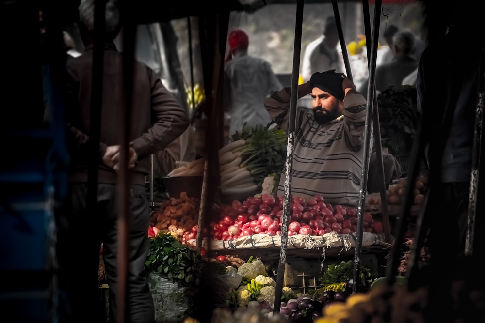 man sitting in front of brown vegetable