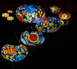 Group of mosaic lamps arranged artistically on a sleek black surface