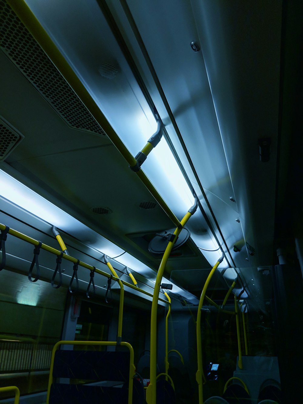 the interior of a public transit bus at night