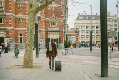 A scenic view of a happy traveler exploring a vibrant city with a suitcase.