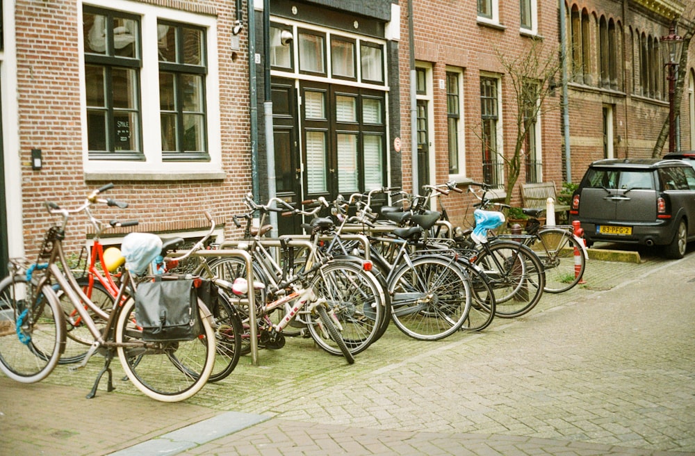 assorted-color bike lot on brown building