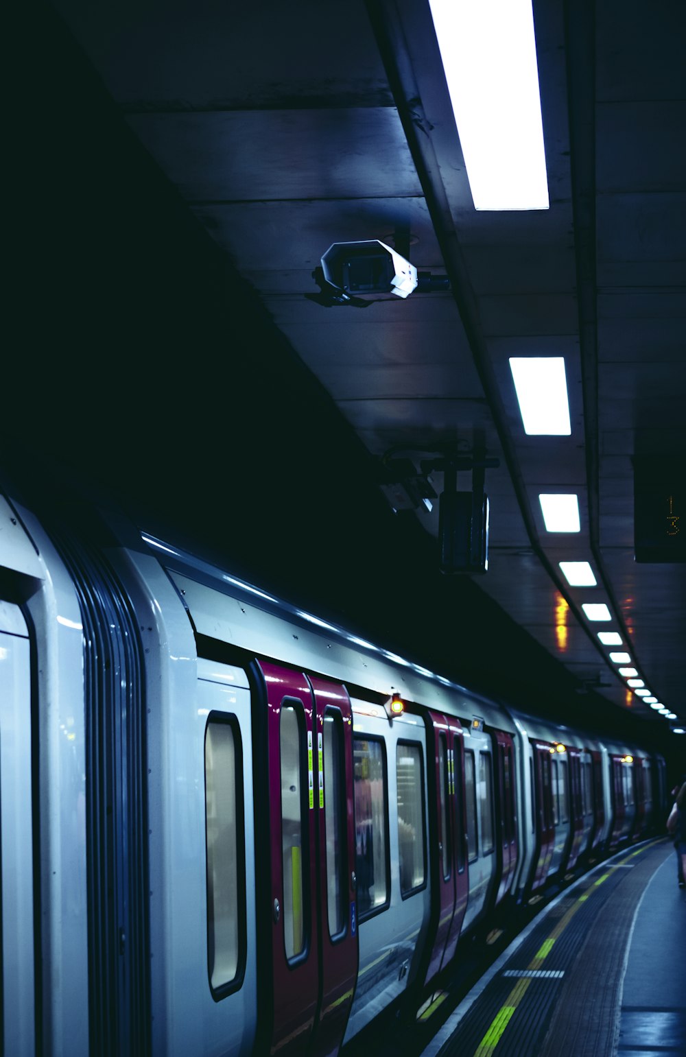 white and red train in train station