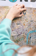 A friendly property expert showing a client a map of potential investment areas in the East Midlands.