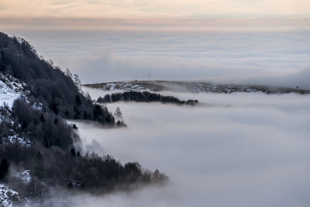 a mountain covered in fog and low lying clouds