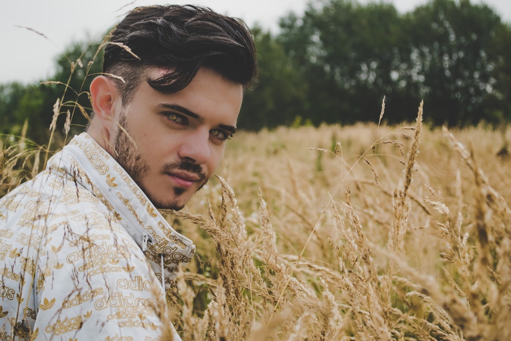 man in white and brown collared shirt in rice field