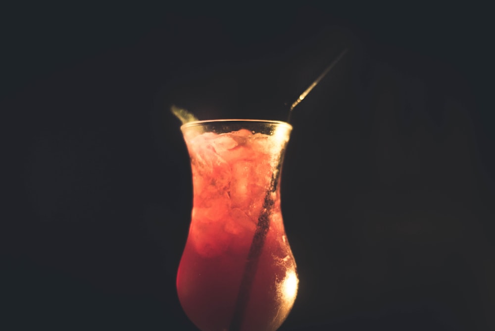 red and beige liquid in clear cocktail glass