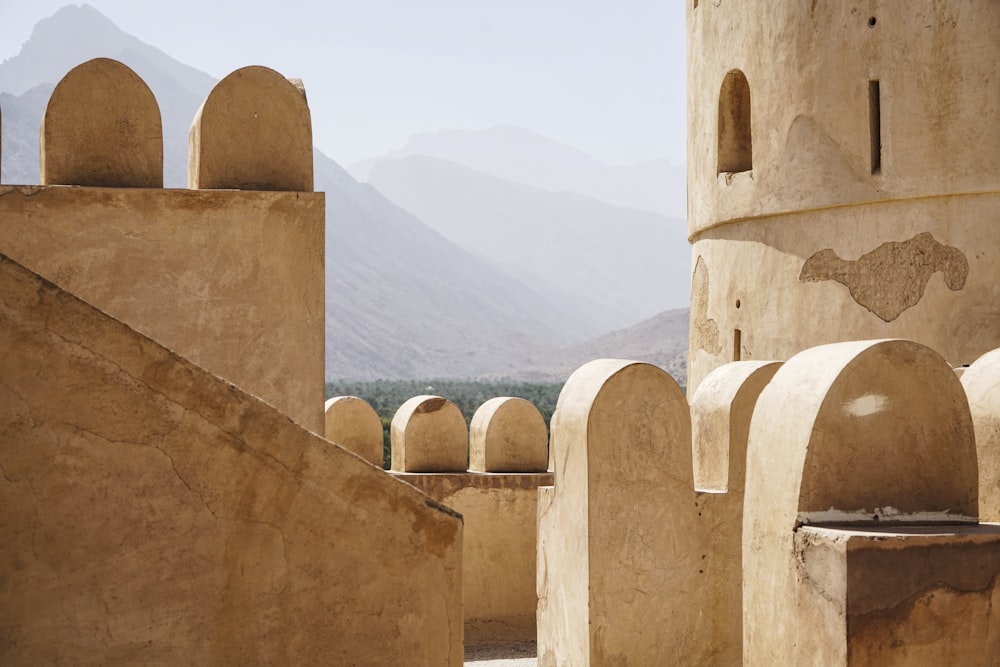 brown concrete building overlooking mountains