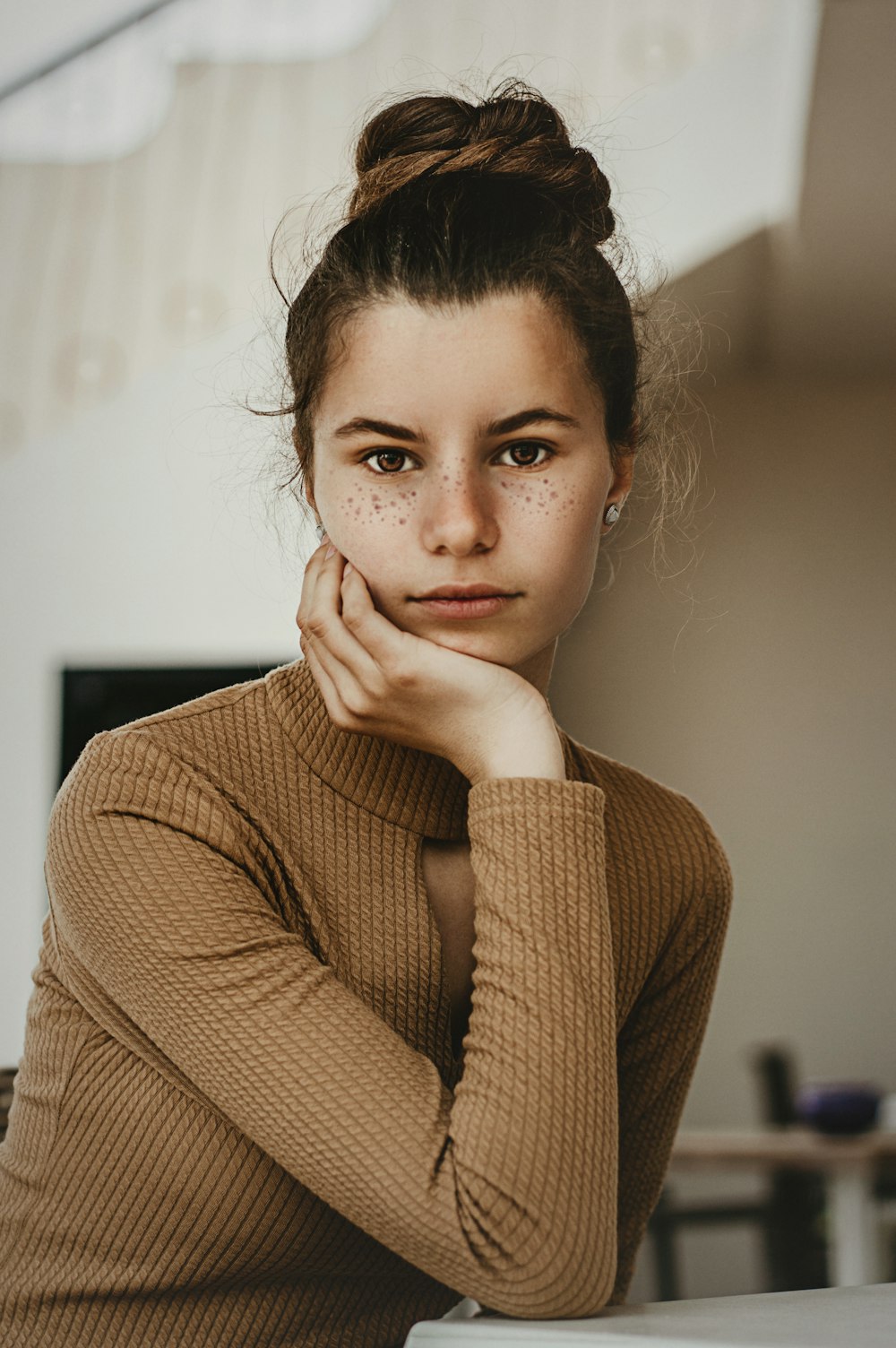 selective focus photography of woman resting head on right hand