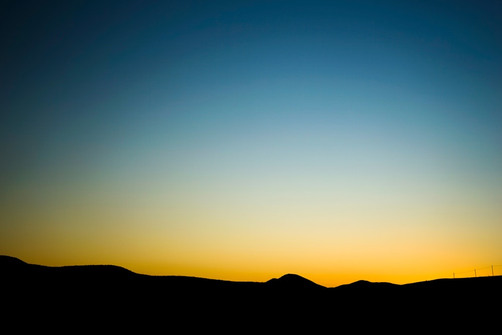 silhouette of mountain during golden hour