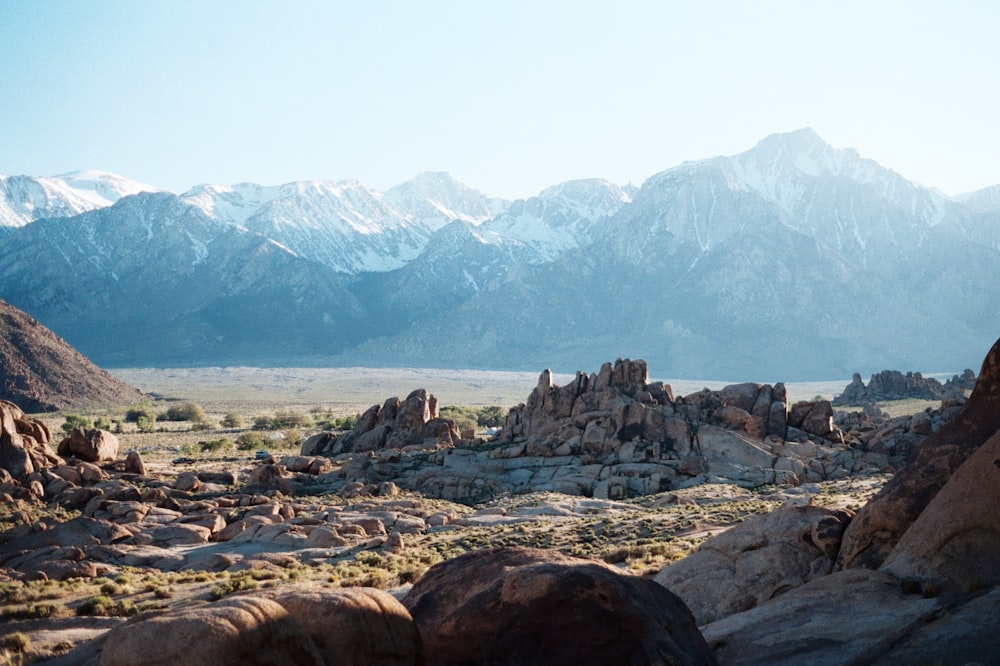 snow capped mountain range across brown mesa