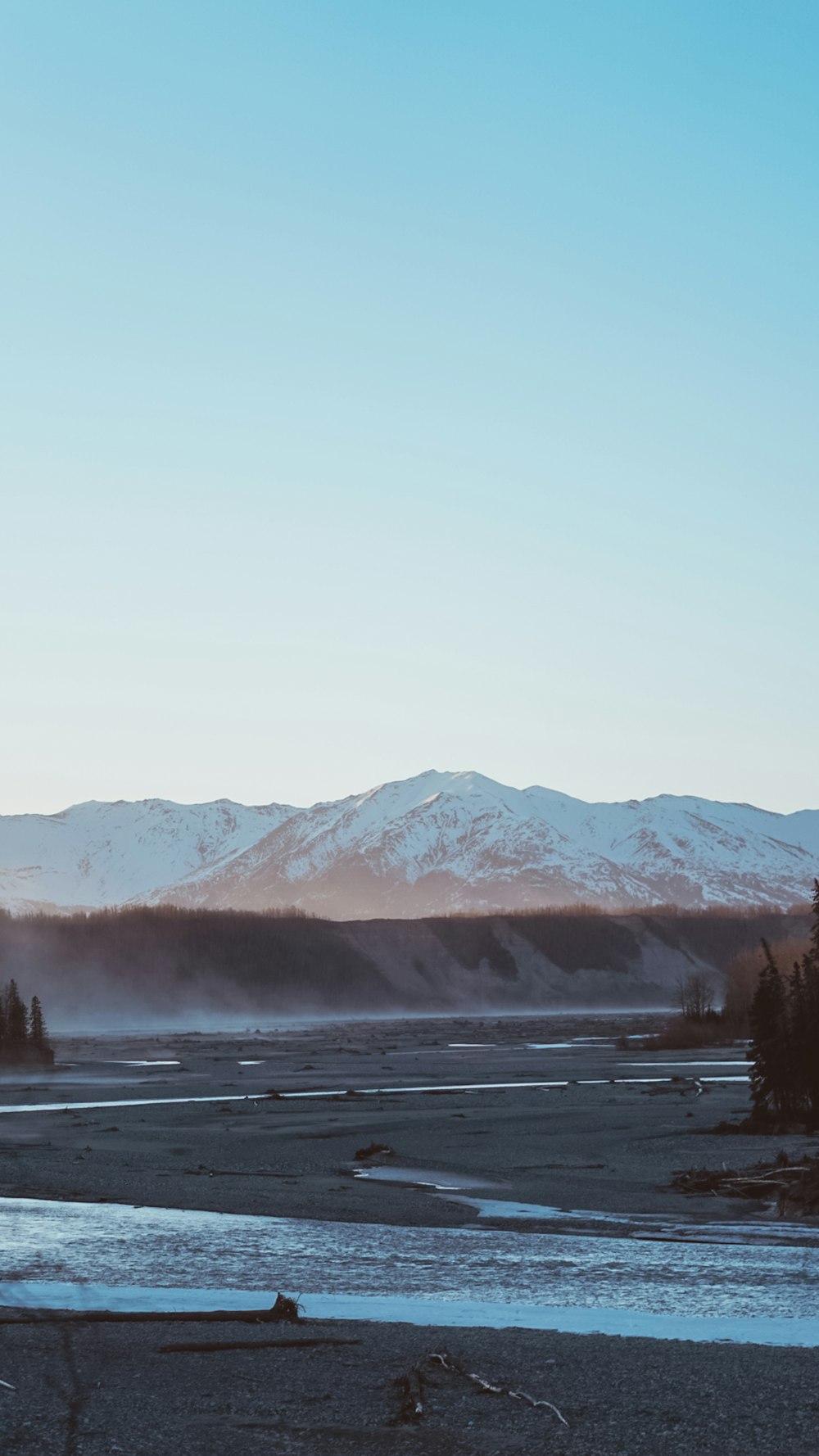 snow capped mountain peak across valley