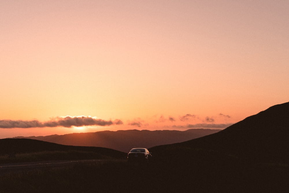 black sedan on road during golden hour