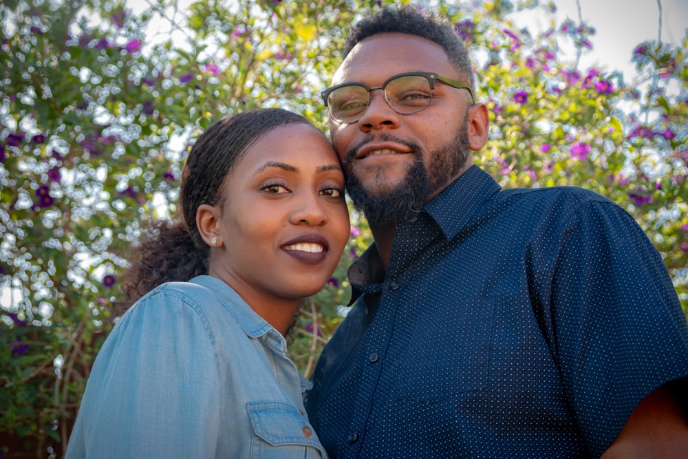 man wearing blue collared top and woman wearing teal collared top