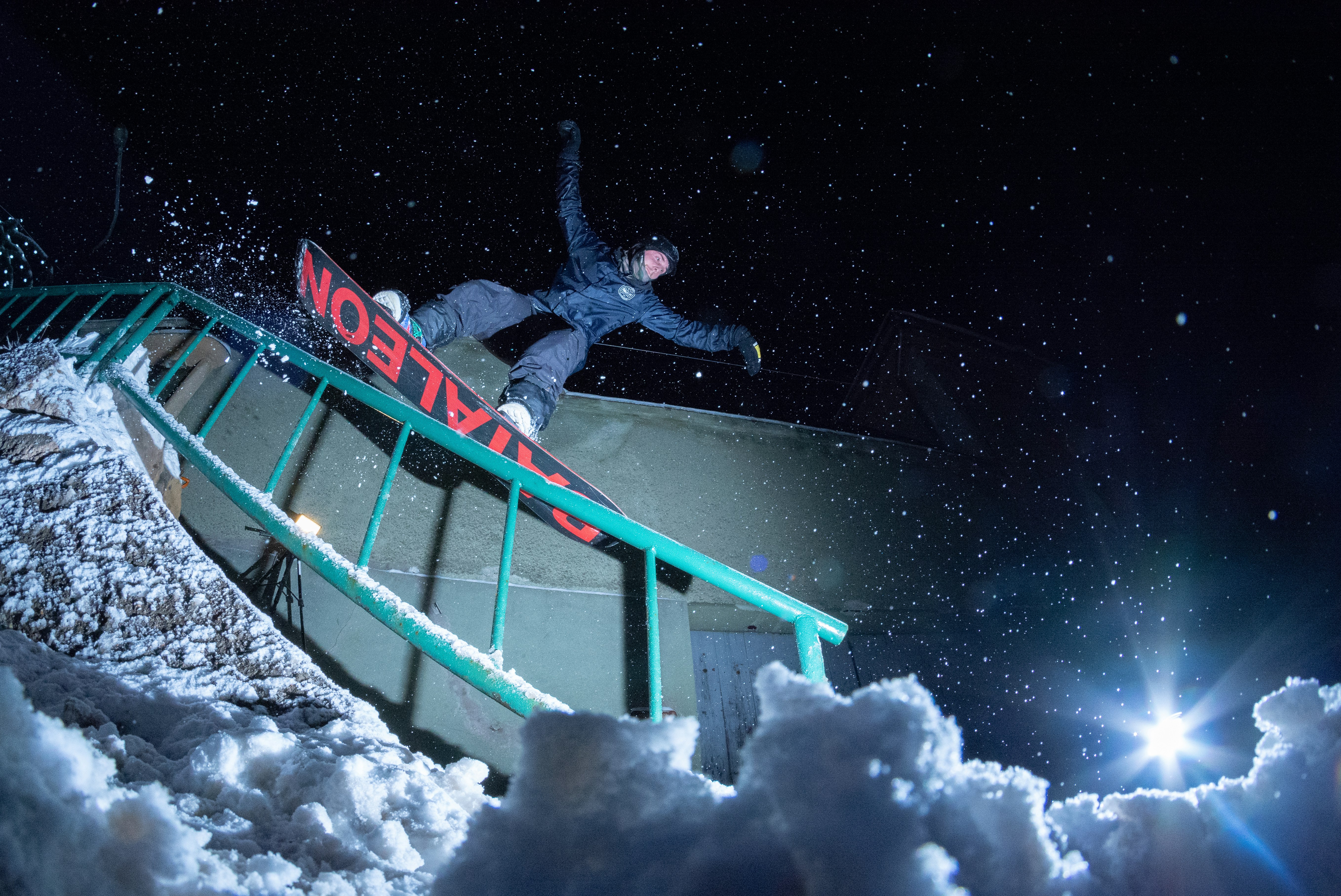 man riding on snowboard at nighttime