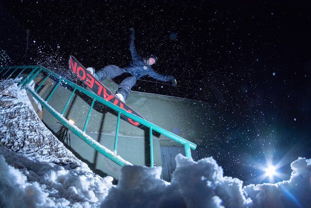 man riding on snowboard at nighttime