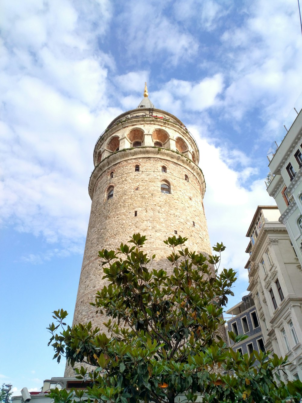 low angle view of tower under cloudy sky