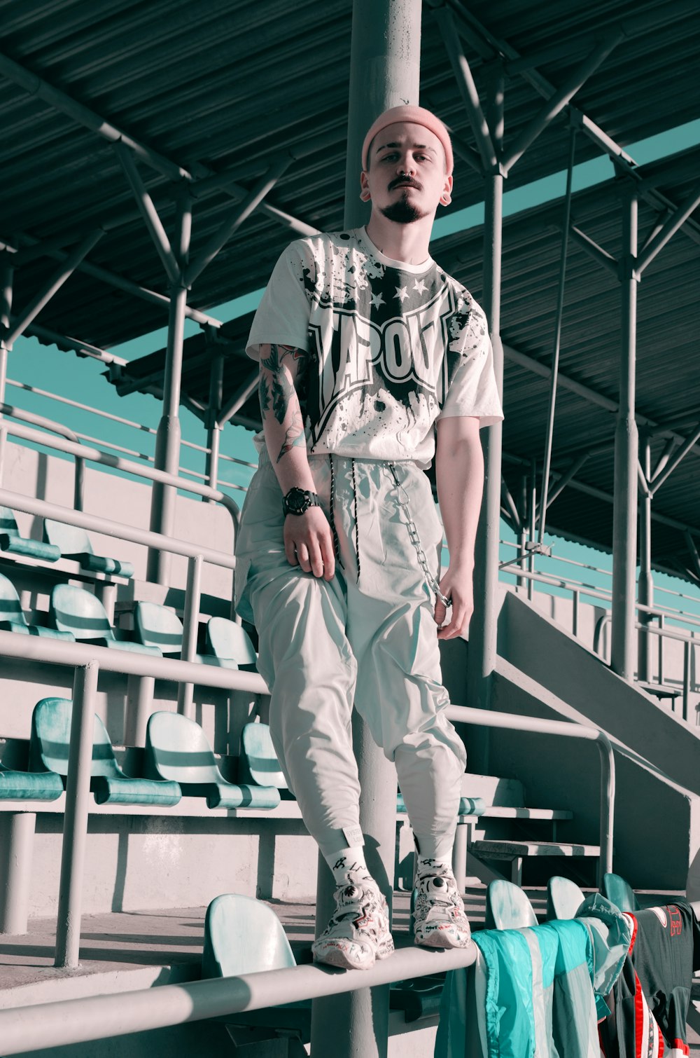 man standing on metal railing